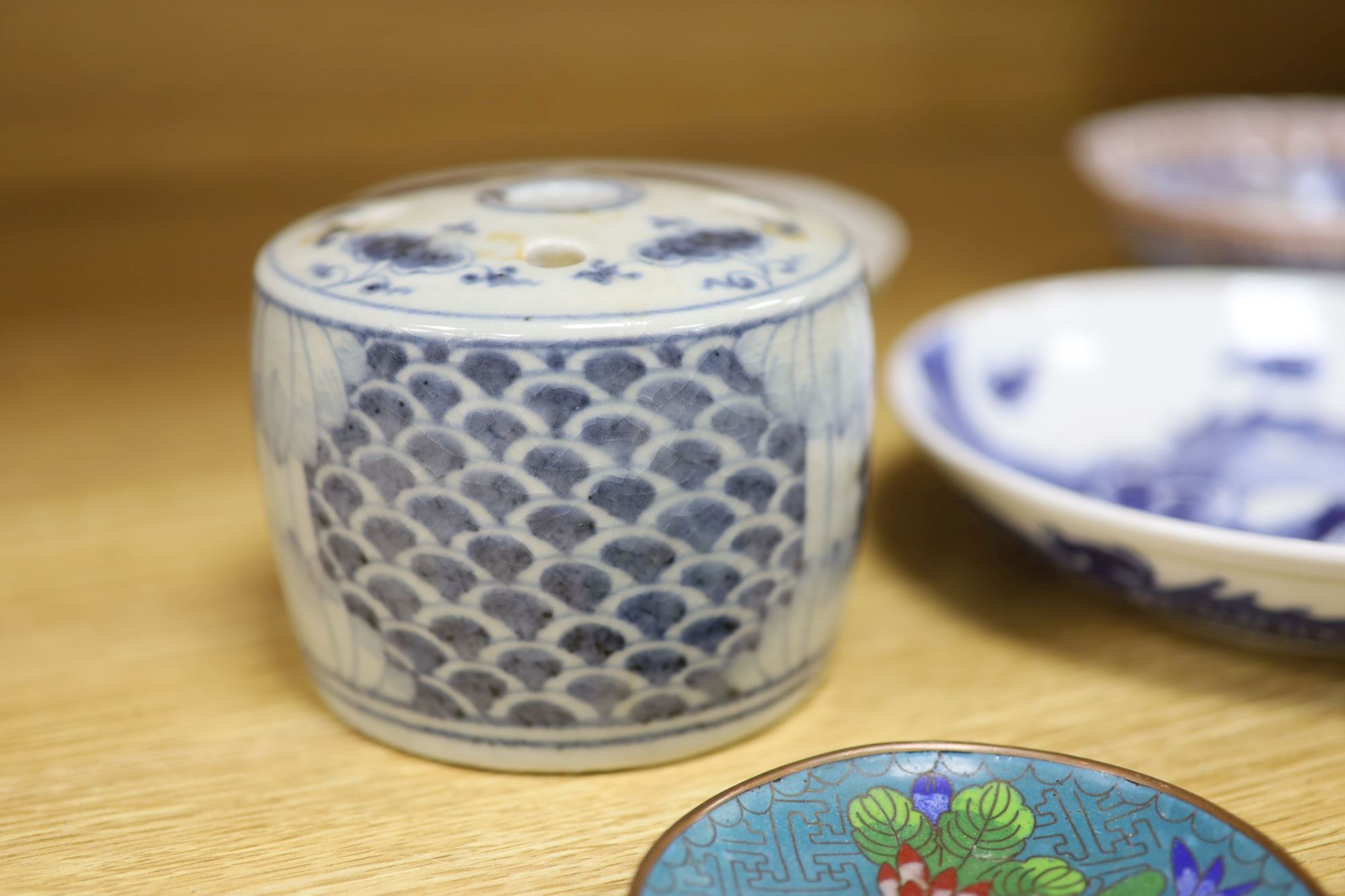 A quantity of Chinese and Japanese ceramics, including a blue and white dragon dish, a Cantonese famille rose dish, four cloisonne pi